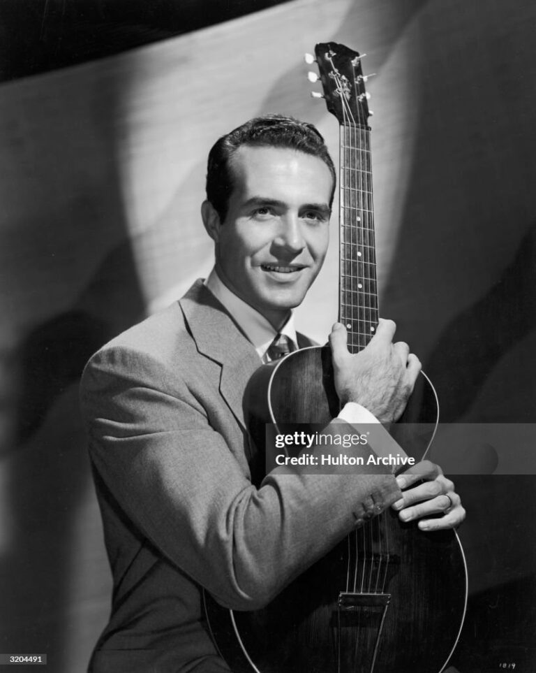 circa 1945:  Portrait of Mexican-born actor Ricardo Montalban, holding an acoustic guitar upright.  (Photo by Hulton Archive/Getty Images)