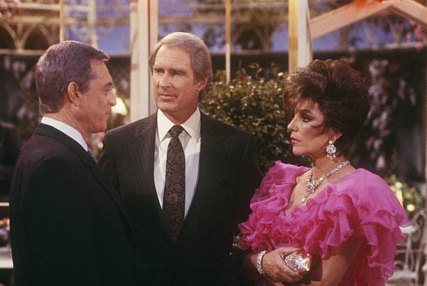 DYNASTY - "The Garage" - Airdate March 11, 1987. (Photo by ABC Photo Archives/Disney General Entertainment Content via Getty Images) PAUL BURKE;JOHN CYPHER;JOAN COLLINS