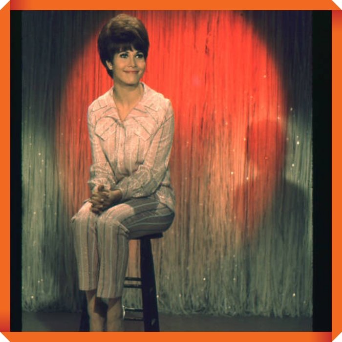 American actor Michele Lee sits on a stool on the set of 'The Tonight Show,' New York, New York, between 1962 and 1972. (Photo by Raimondo Borea/Gartenberg Media Enterprises/Getty Images)